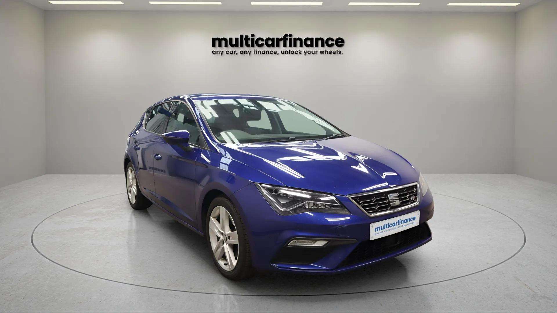 A blue 2019 SEAT Leon petrol hatchback with automatic transmission, available on PCP and HP finance at MultiCar Finance, showcasing its sporty design and dynamic appeal.